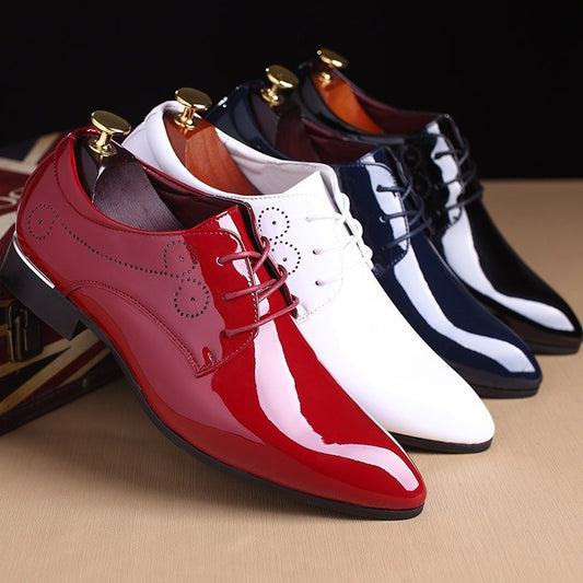 Four pairs of glossy dress shoes in red, white, black, and blue on a beige surface.