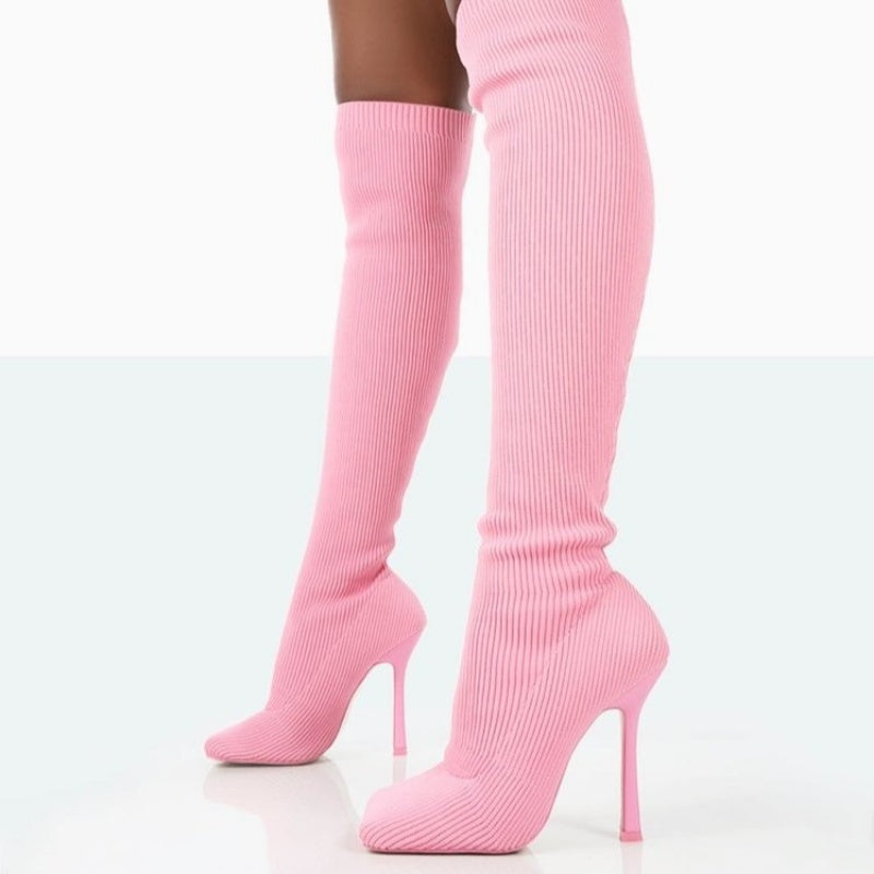 Pink knee-high boots with high heels on a white background