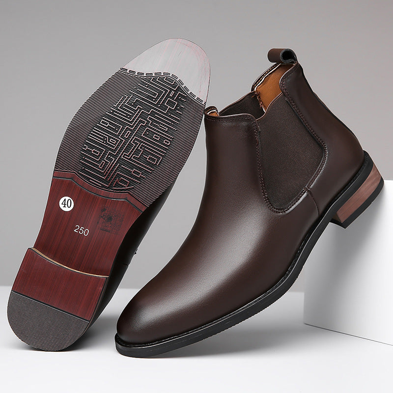 Brown leather Chelsea boots with a close-up of the sole on a gray background