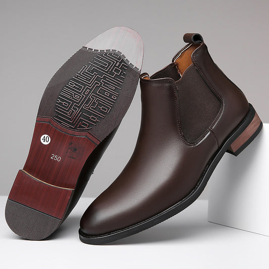 Brown leather Chelsea boots with a close-up of the sole on a gray background